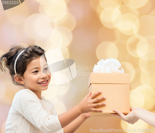 Image of smiling little girl with gift box