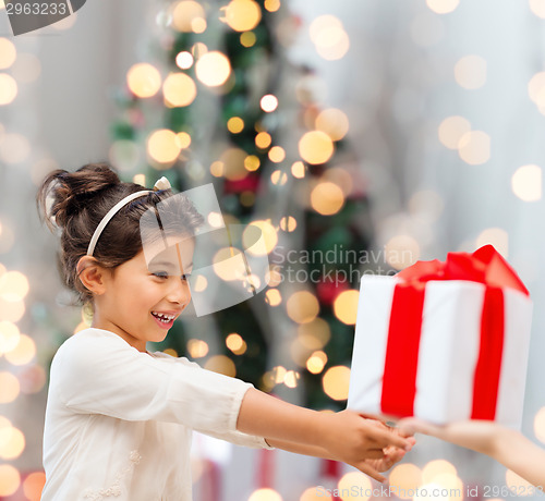 Image of smiling little girl with gift box