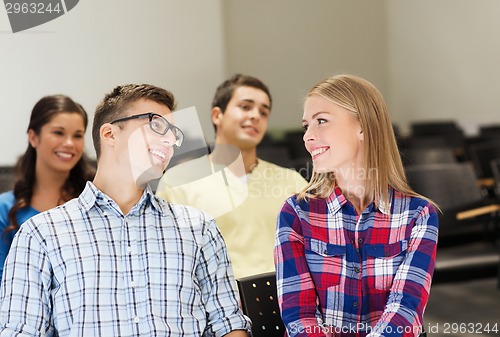 Image of group of smiling students in lecture hall