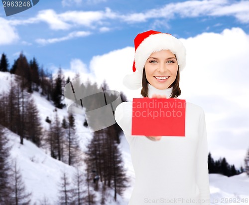 Image of woman in santa helper hat with blank red card