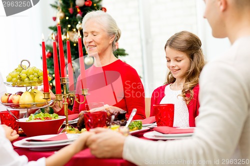 Image of smiling family having holiday dinner at home