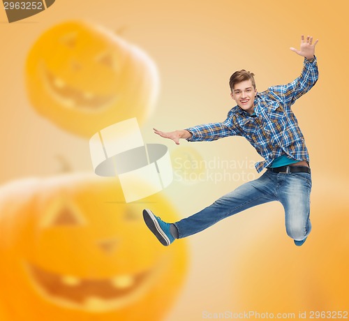 Image of smiling young man jumping in air