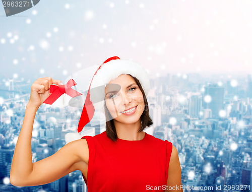 Image of smiling woman in santa hat with jingle bells