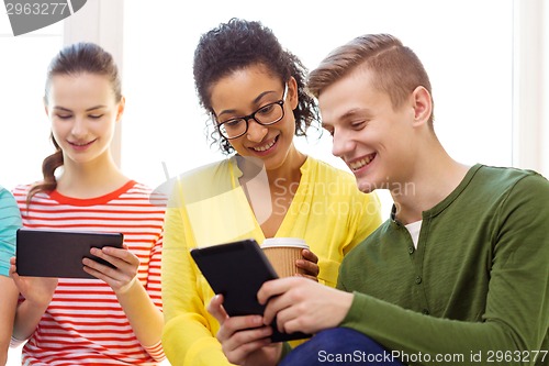 Image of smiling students with tablet pc at school