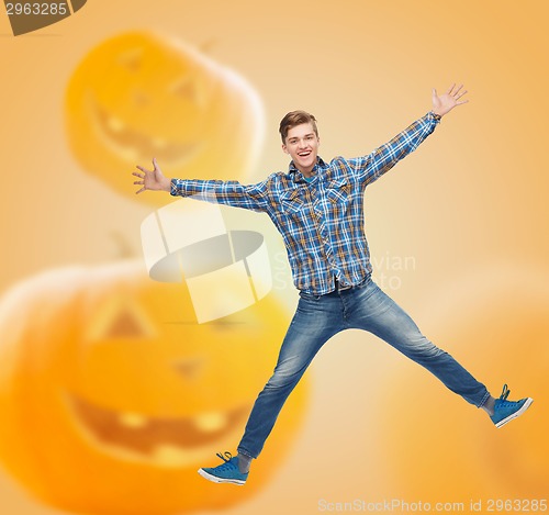 Image of smiling young man jumping in air