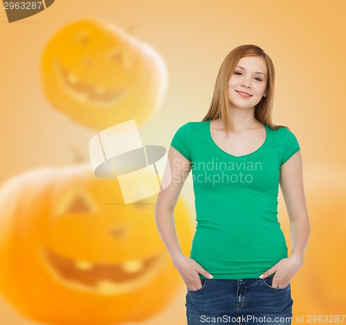 Image of smiling young woman in blank green t-shirt