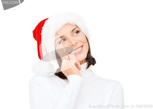 Image of thinking and smiling woman in santa helper hat