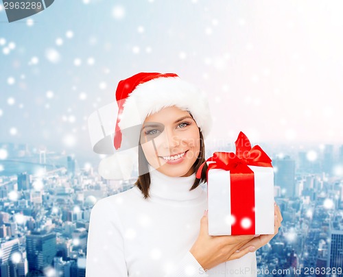 Image of smiling woman in santa helper hat with gift box