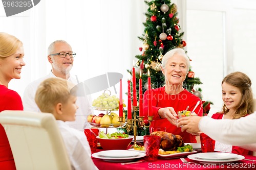 Image of smiling family having holiday dinner at home