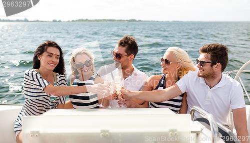 Image of smiling friends with glasses of champagne on yacht