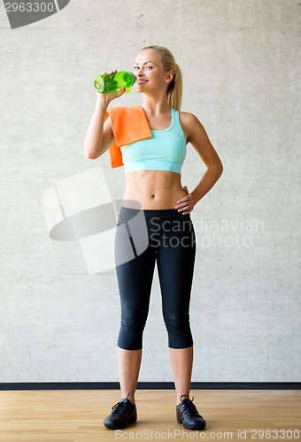 Image of woman with bottle of water in gym