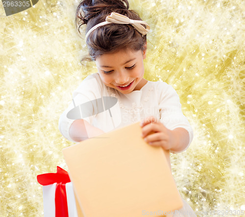 Image of smiling little girl with gift box