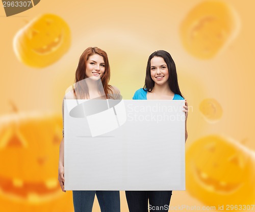 Image of smiling teenage girls with white board