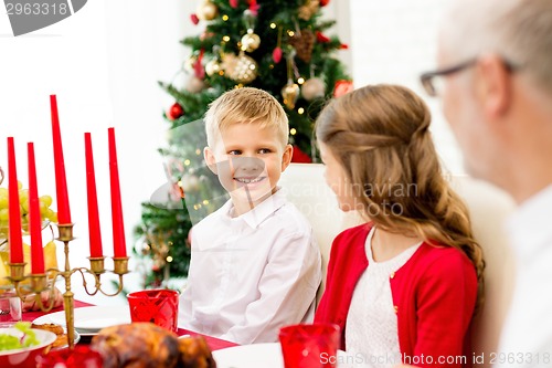 Image of smiling family having holiday dinner at home