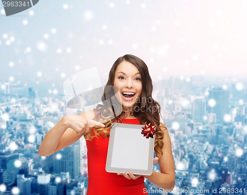 Image of smiling woman in red dress with tablet pc