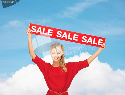 Image of woman in red dress with sale sign