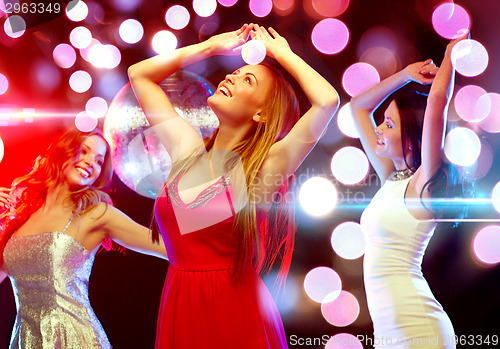 Image of three smiling women dancing in the club