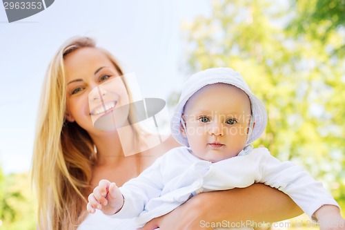 Image of happy mother with little baby in park