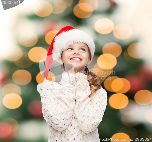 Image of dreaming girl in santa helper hat