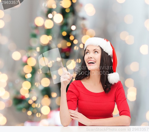 Image of smiling woman in santa helper hat