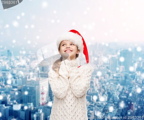 Image of dreaming girl in santa helper hat