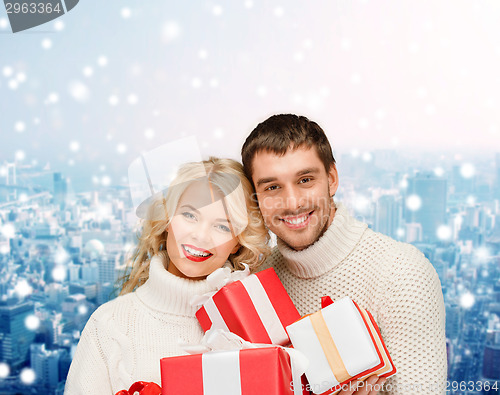 Image of smiling man and woman with presents
