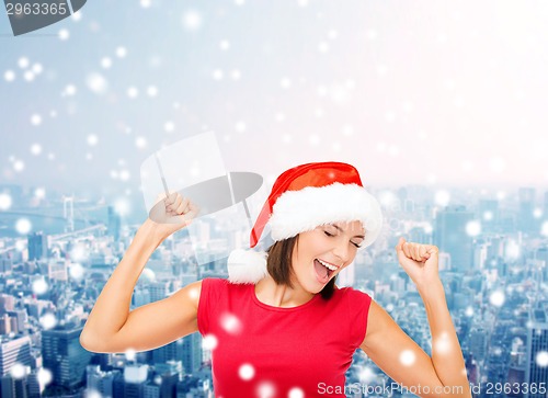 Image of smiling woman in santa helper hat