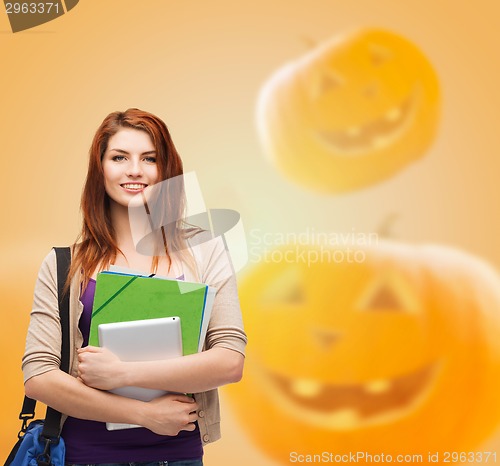 Image of smiling student girl with books and bag