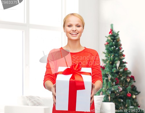 Image of smiling woman in red clothes with gift box