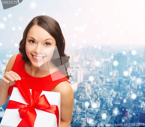 Image of smiling woman in red dress with gift boxes