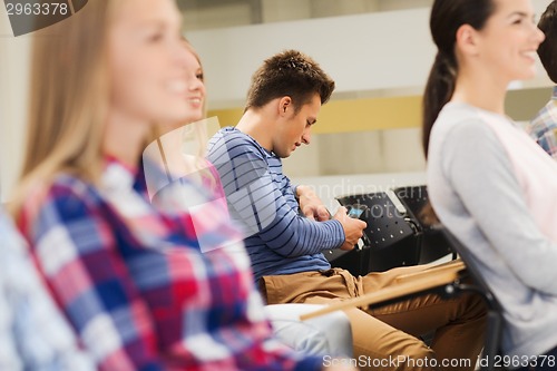 Image of group of smiling students in lecture hall