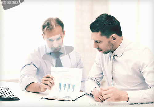 Image of businessmen with notebook on meeting
