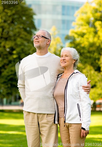 Image of senior couple hugging in city park