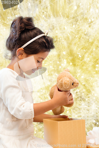 Image of smiling little girl with gift box