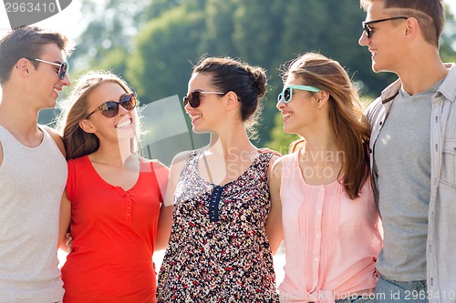 Image of group of smiling friends in city