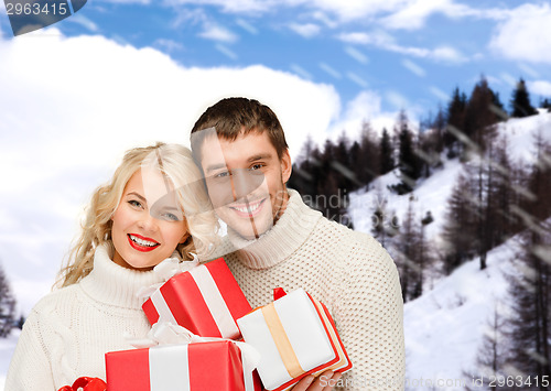 Image of smiling man and woman with presents