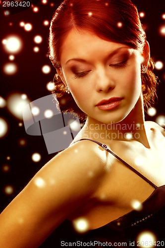 Image of woman in evening dress wearing diamond earrings