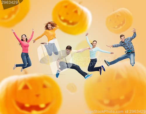 Image of group of smiling teenagers jumping in air