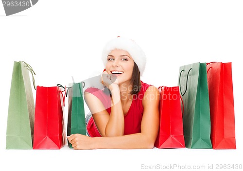 Image of woman in red shirt with shopping bags