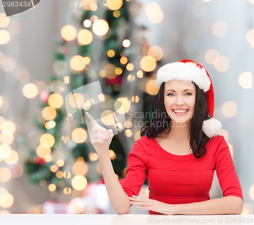 Image of smiling woman in santa helper hat