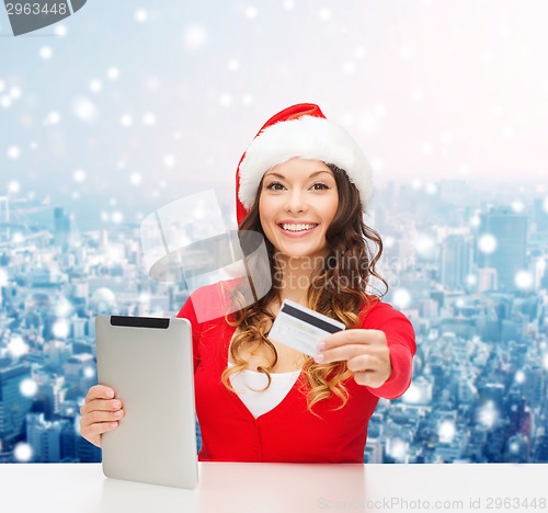 Image of woman in santa hat with tablet pc and credit card