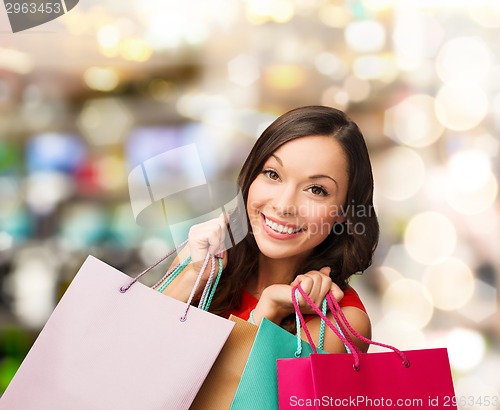 Image of woman in red dress with shopping bags