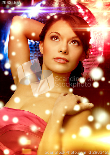 Image of woman in evening dress wearing diamond earrings