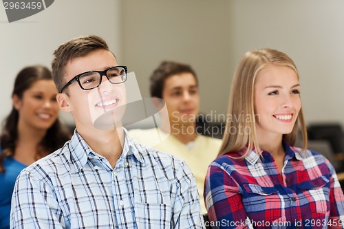 Image of group of smiling students in lecture hall