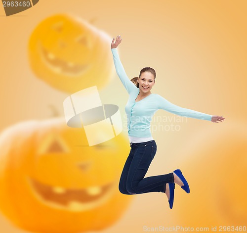 Image of smiling young woman jumping in air