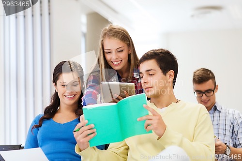 Image of group of smiling students with tablet pc