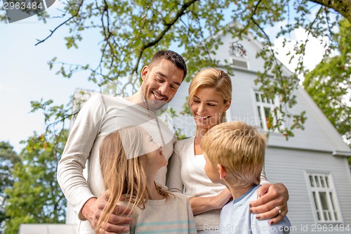 Image of happy family in front of house outdoors