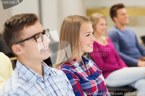 Image of group of smiling students in lecture hall