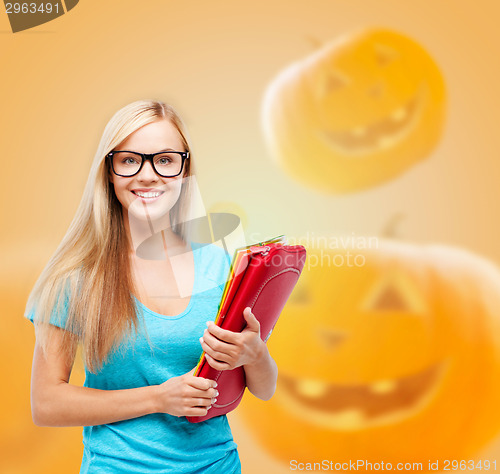 Image of smiling student girl with books and backpack