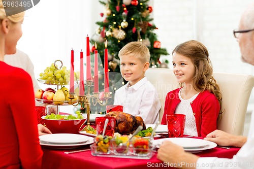 Image of smiling family having holiday dinner at home